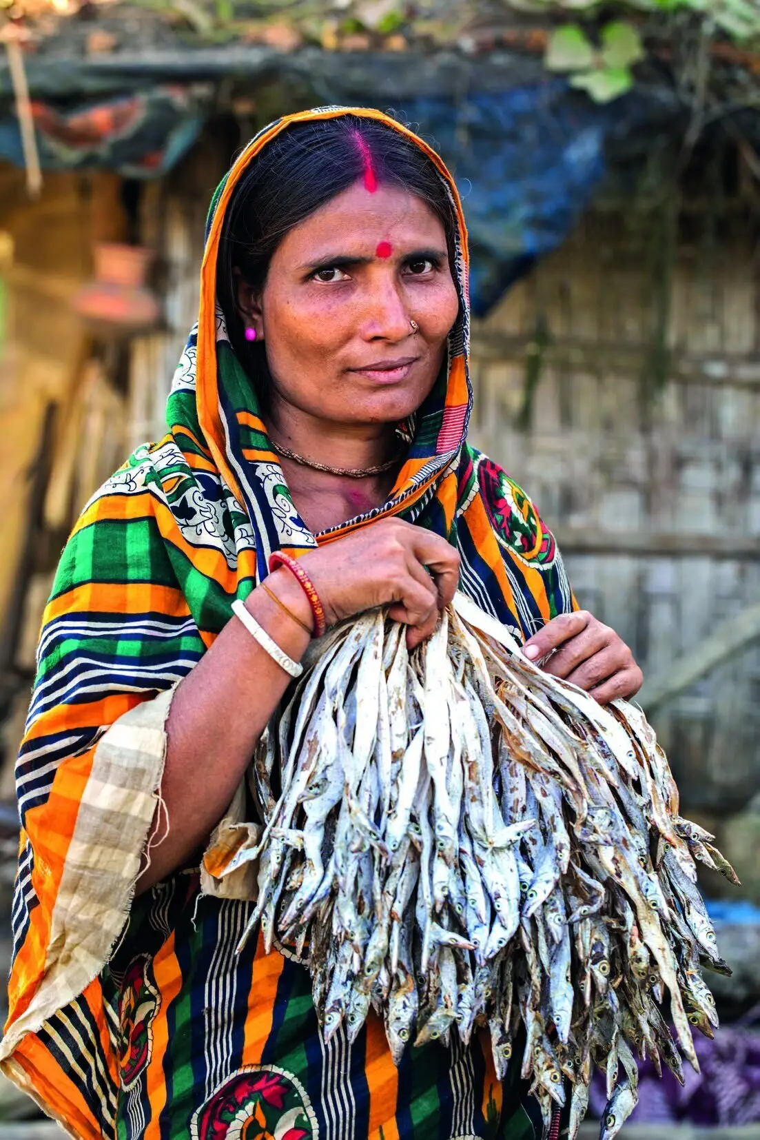 A fisherwoman holding her catch